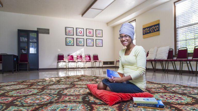 Student kneeling in sacred space