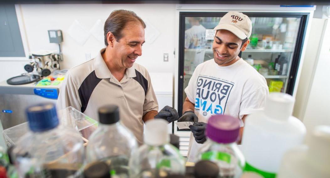 student and professor in the lab