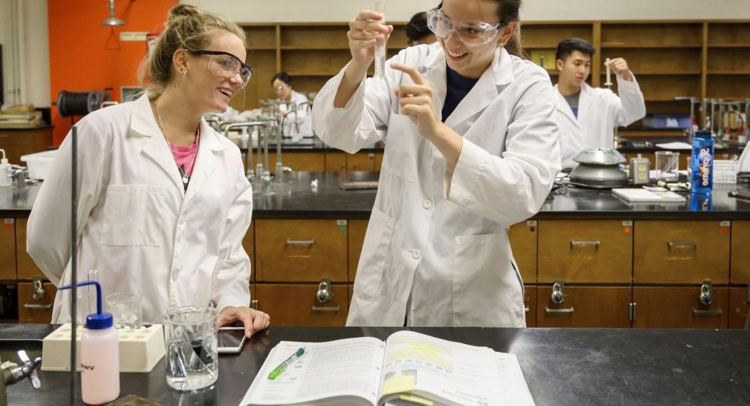 chemistry students performing lab tests